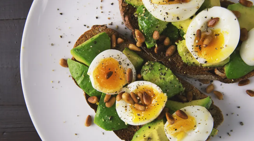 avocado toast with hard boiled eggs and pine nuts