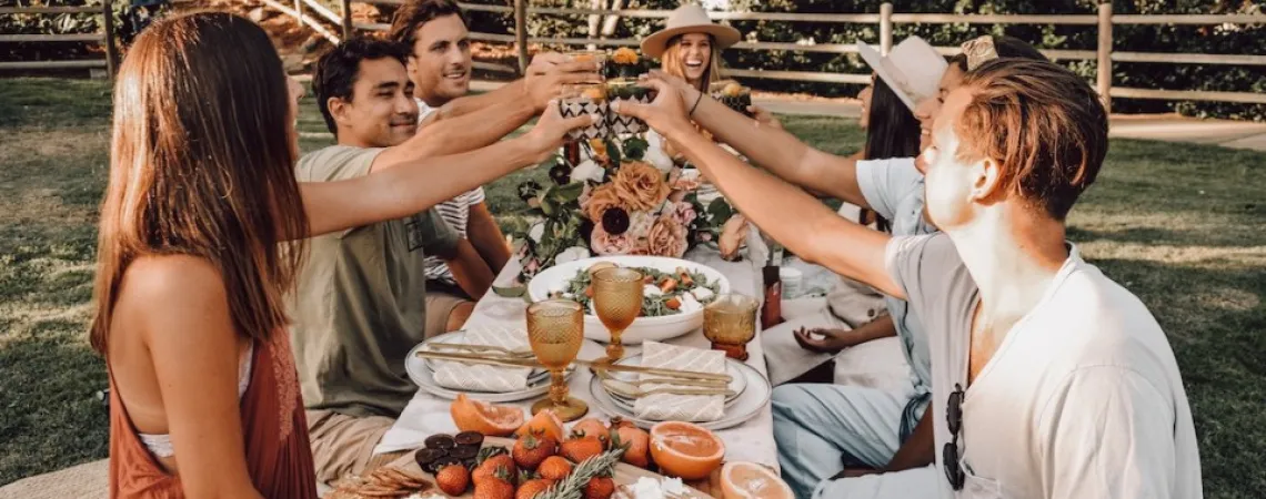 festive young adults celebrating by eating out