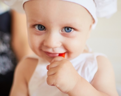 enfant aux yeux bleus avec une toque de cuisinier