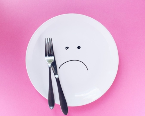 Assiette triste vide avec une fourchette et un couteau