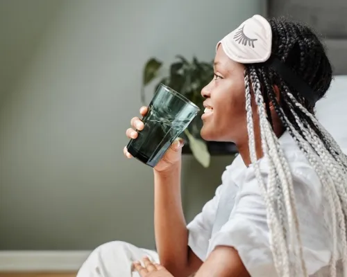 Femme qui boit de l'eau en pyjama - Woman drinking water in her pyjamas