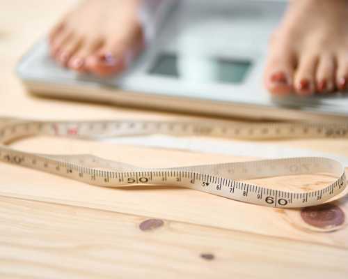 Pieds sur une balance avec ruban à mesurer - Feet on scale with measuring tape