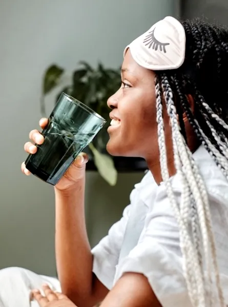 Femme qui boit de l'eau en pyjama - Woman drinking water in her pyjamas