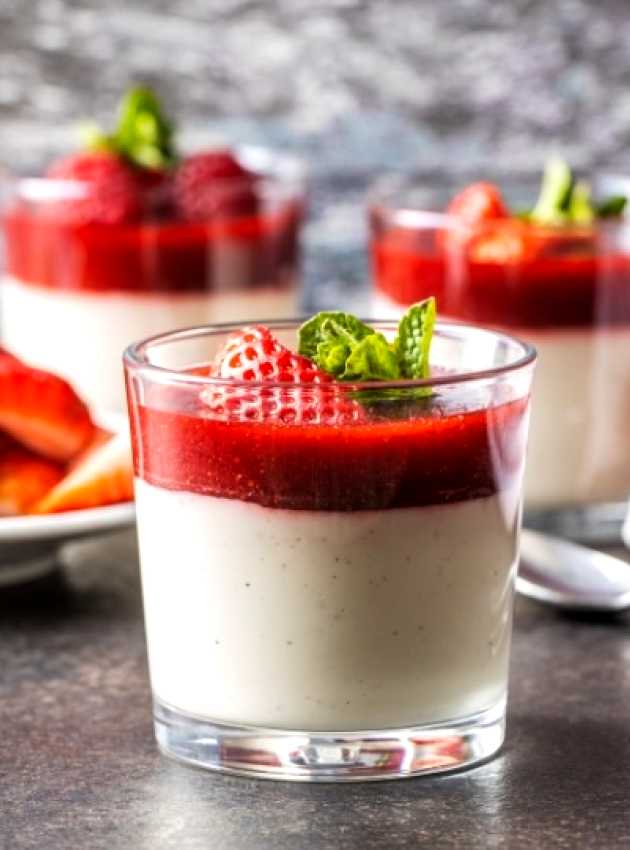 Delicate dessert topped with fresh strawberry sauce and berries, ready to be enjoyed, highlighting a healthy and elegant treat.